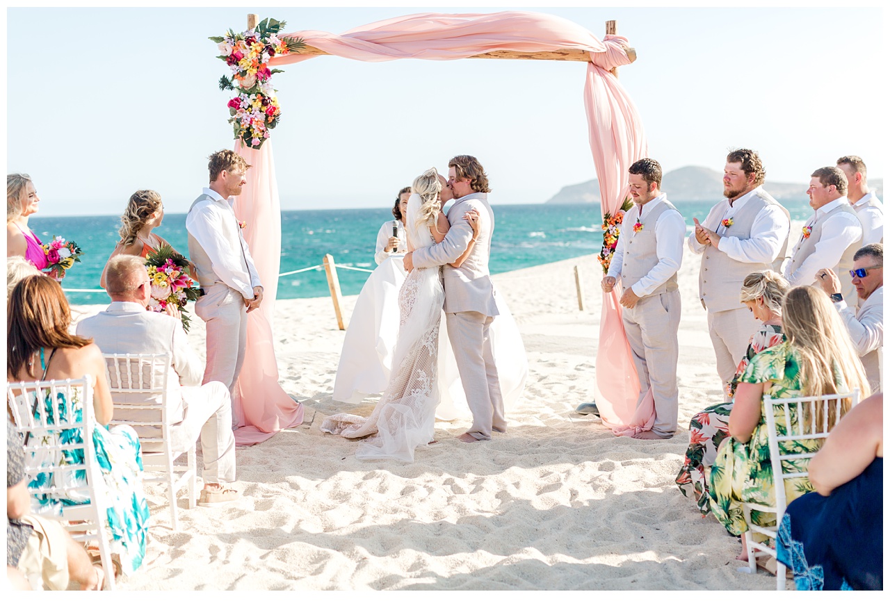 Couple kiss after exchanging vows at Dreams Los Cabos destination wedding. 