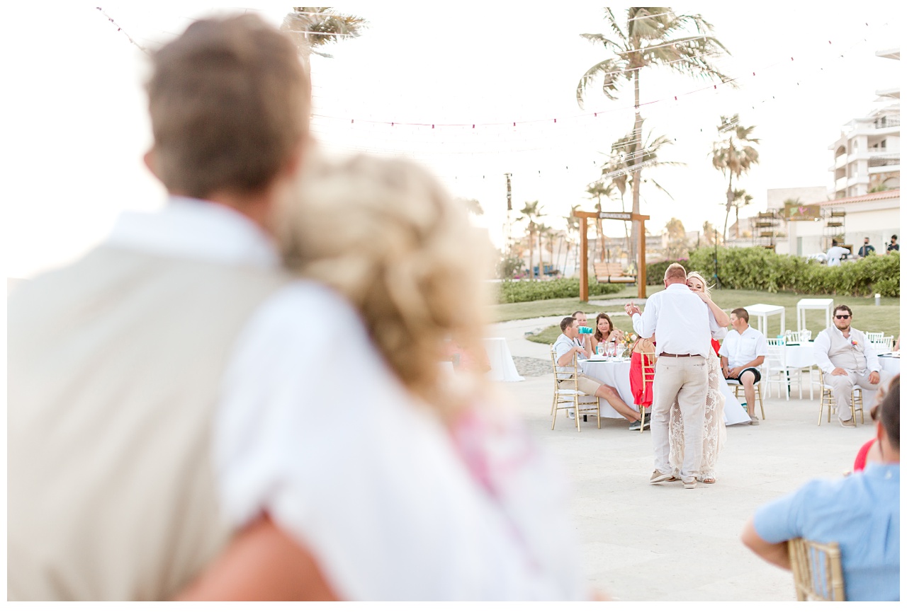 Father and bride dance in front of wedding goers at Dreams Los Cabos. 