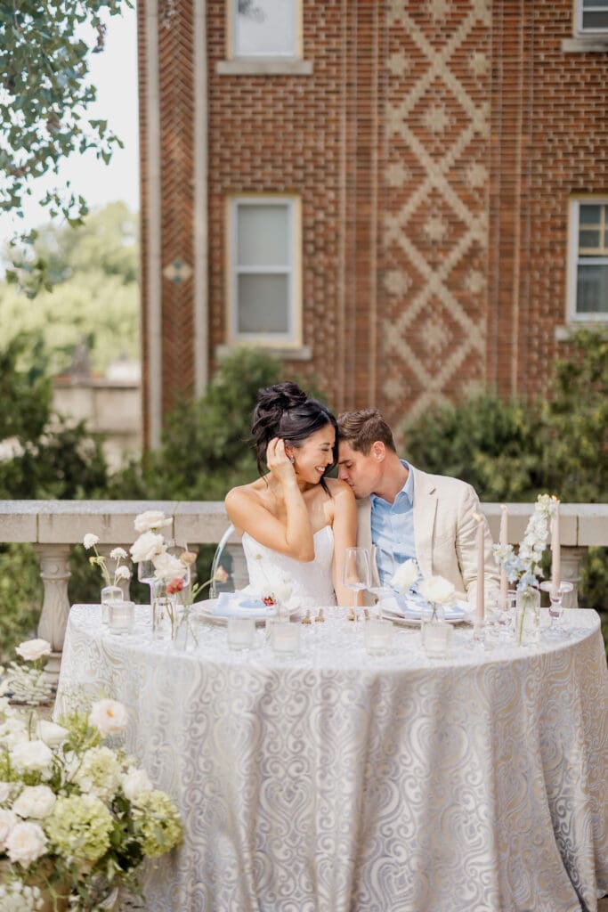 wedding couple has a private cocktail hour on the balcony for a quiet moment alone